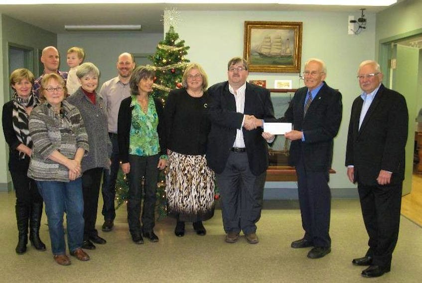 <p>Harold Bulger, deputy mayor for the Town of Hantsport and chairperson of the library committee, accepts a $100,000 donation a few relatives of the late Isabel and Roy Jodrey contributed to the Hantsport Library Relocation and Renovation Project. (Submitted photo)</p>