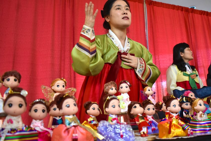 Polly Lim, who is originally from South Korea, talks about the hanbok dolls she makes during the Lunar New Year celebration at Cape Breton University on Thursday. Hanbok is in a traditional Korean dress worn during occasions such as festivals, celebrations and ceremonies. Chris Connors/Cape Breton Post