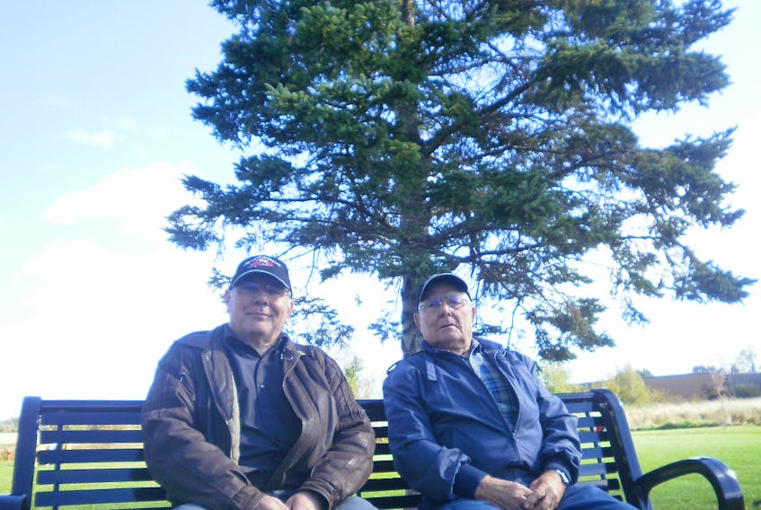 Lewis and Harold Benedict take a brief timeout to enjoy the scenery in Port Williams. - Contributed