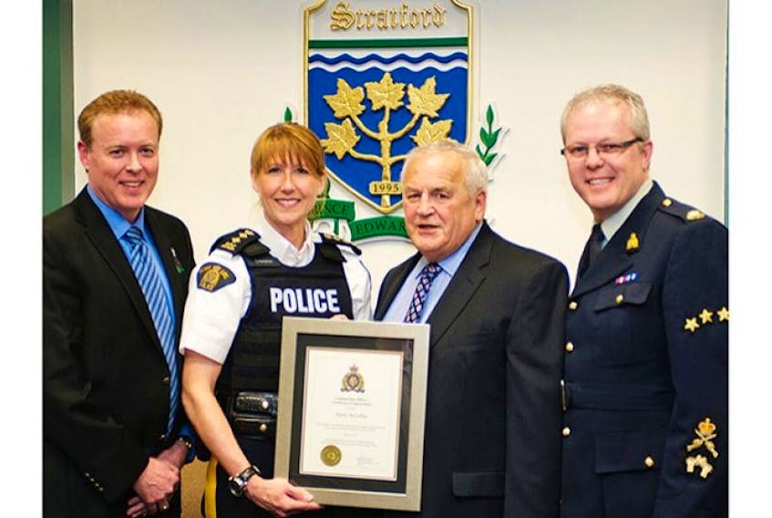 <p>Stratford resident Harry McLellan, second right, who was the driving force behind the town’s Citizens on Patrol group, is moving to British Columbia. To show appreciation for his volunteer work, town council and the RCMP’s top brass presented him with a plaque during the regular meeting of council Wednesday night. From left, are Mayor David Dunphy, Joanne Crampton, chief superintendent of RCMP L Division, and Staff Sgt. Mark Crowther, commander of RCMP Queens district.</p>