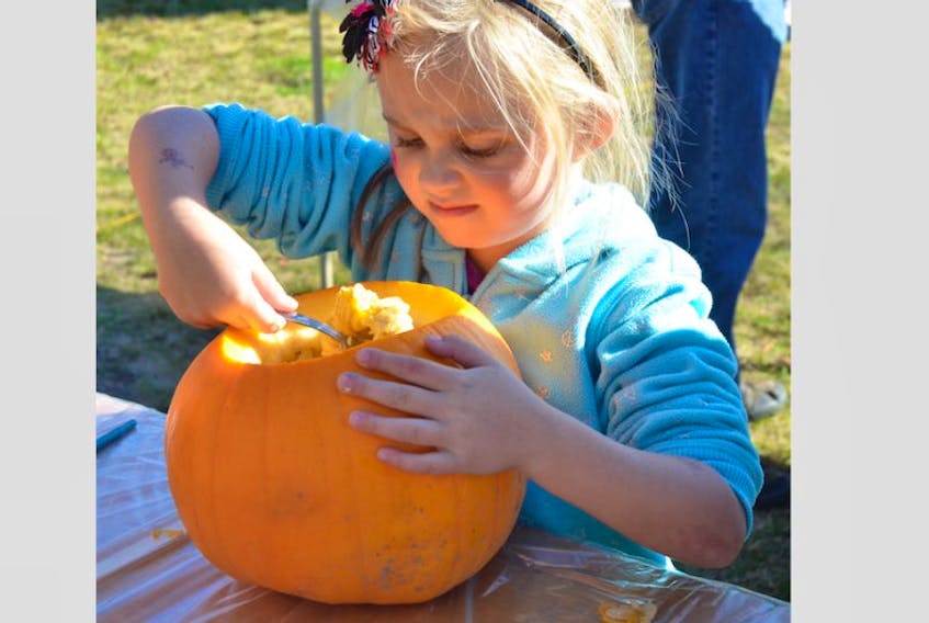 <p>A child carves a pumpkin at a previous Harvest Fair.&nbsp;</p>