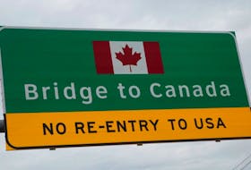 A "Bridge to Canada" sign is seen directing traffic to the Ambassador Bridge, during the coronavirus disease outbreak, at the international border crossing, which connects with Windsor, Ontario, in Detroit, Michigan, U.S., March 18, 2020.      