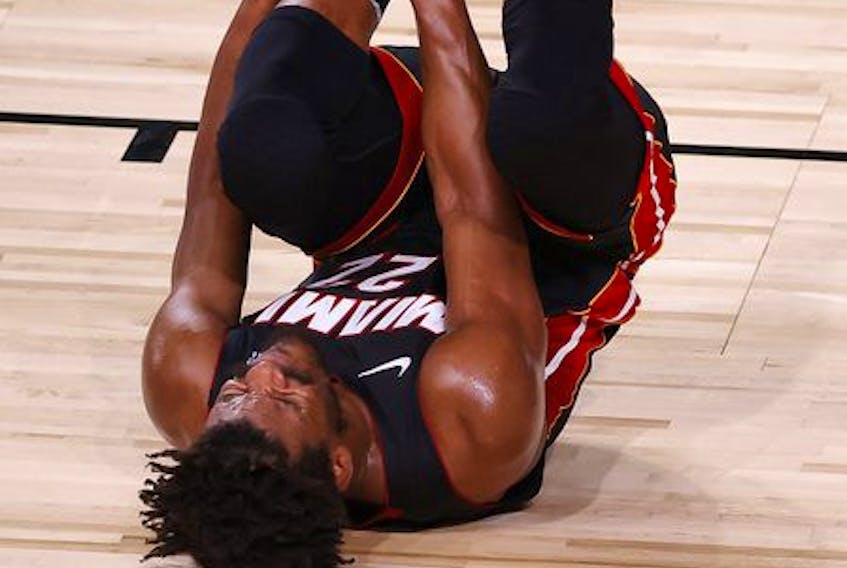 Jimmy Butler of the Miami Heat reacts after rolling his ankle during Game 1 of  The Finals against the Los Angeles Lakers at the ESPN Wide World Of Sports Complex on Wednesday night in Lake Buena Vista, Fla. Butler plans to play through the pain in Game 2. 