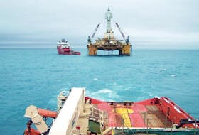 The deepwater rig, Henry Goodrich, prepares to move to the Flemish Pass to drill a second Mizzen well for Statoil Canada. Alongside the rig is the anchor-handling tug, Skandi Vega in this undated photo. The rig, now&nbsp; at the North Amethyst site near the White Rose oilfield, has had operations temporarily suspended after an incident last week. — Submitted file photo