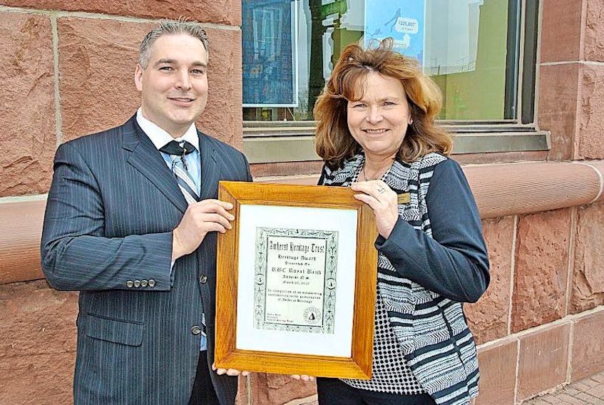 Justin Helm of the Amherst Heritage Trust presents a Heritage Award to Laura Landriault, RBC Amherst Branch manager, recognizing the bank’s restoration project to its 113-year-old building.