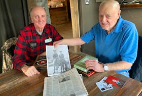 Sam Moses and Fred LeBlanc, who served together in the military in the 1950s, recently reconnected for the first time in decades after Moses read a story about LeBlanc in The Southwest Wire publication. In photo Fred holds a photograph of a younger version of the two. TINA COMEAU PHOTO