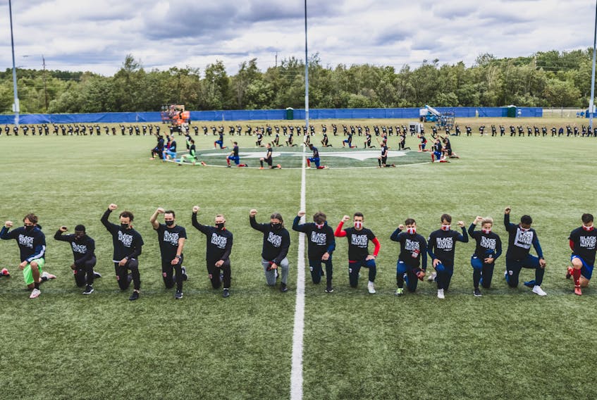 Players from all eight Canadian Premier League teams take a knee   in a show of solidarity against racism during a break in action at the 8:46 mark of a game between Cavalry FC and Atletico Ottawa on Thursday in Charlottetown.  Chant Photography / CPL