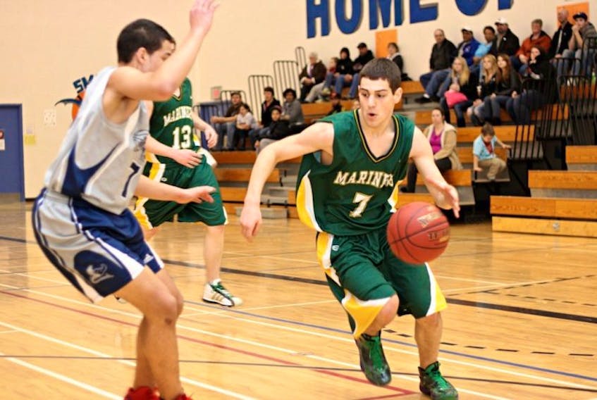 Matthew Hakim of the Digby Mariners drives to the hoop against Shayne Clements of the SMBA Stingrays.