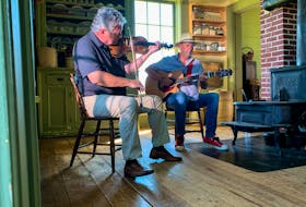 A peek at the first virtual Highland Village Day Concert with Howie MacDonald on fiddle and Buddy MacDonald on guitar in the kitchen of the MacQuarrie-Fox House. CONTRIBUTED
