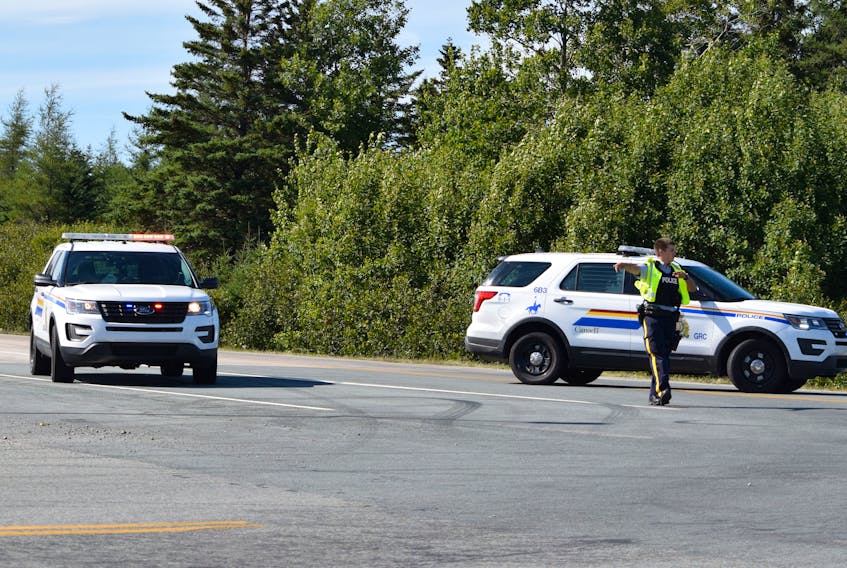 Traffic is re-directed by the RCMP at the Pubnico exit on Highway 103 on Aug. 27. Heavy smoke from a nearby forest fire forced the closure of the highway.