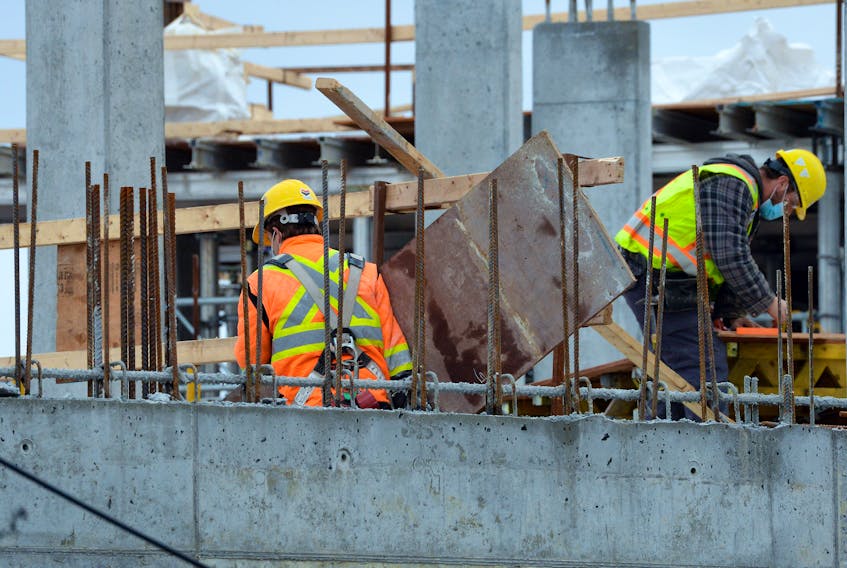 Workers continue construction on a building on Portugal Cove Road in St. John's Tuesday. Results of a quarterly hiring outlook survey suggest a softing hiring pace is expected for the city in the coming months.

Keith Gosse/The Telegram