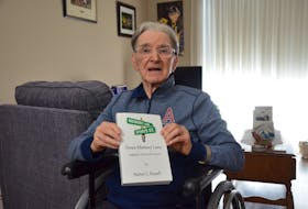 Kentville sports author Burton Russell with his 13th book, Down Memory Lane: Highlights of Kentville Sports. KIRK STARRATT