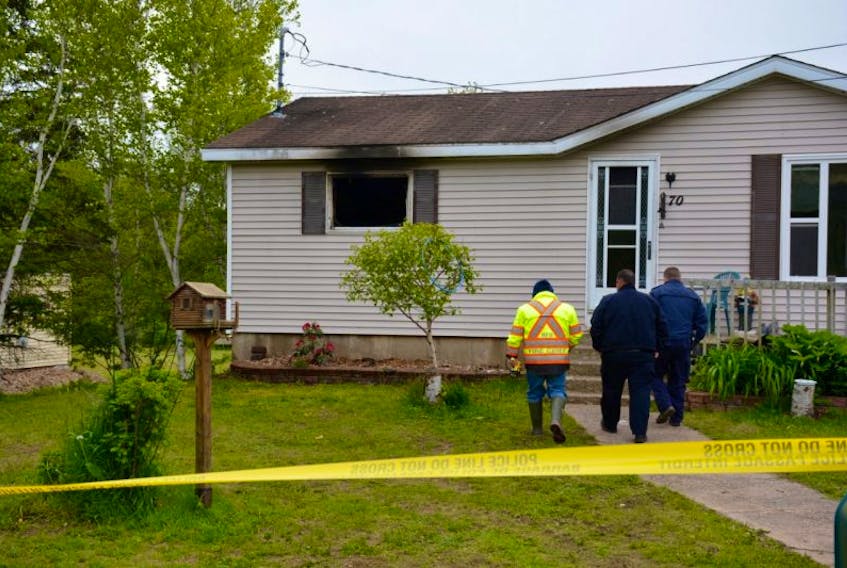 The Brooklyn Fire Chief Andy McDade (left) heads towards the residence with the Fire Marshal and a member of the RCMP.
