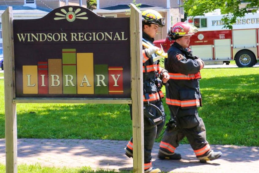 Lieut. Andrew Steeves, right, and firefighter Caleb Matheson exit the Windsor Regional Library after the Windsor Fire Department was called to investigate a smokey smell June 8.