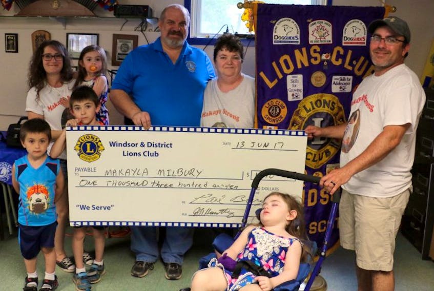 King Lion Paul Burgess of the Windsor Lions Club, centre, presented the Milbury family of Centre Burlington with $1,310 – the amount they raised at a breakfast fundraiser. Pictured here with him are Tracy and Dana Milbury, their children Ethan, Hayden, MacKenzie and Makayla, and Vickie Kennedy, the children's grandmother.