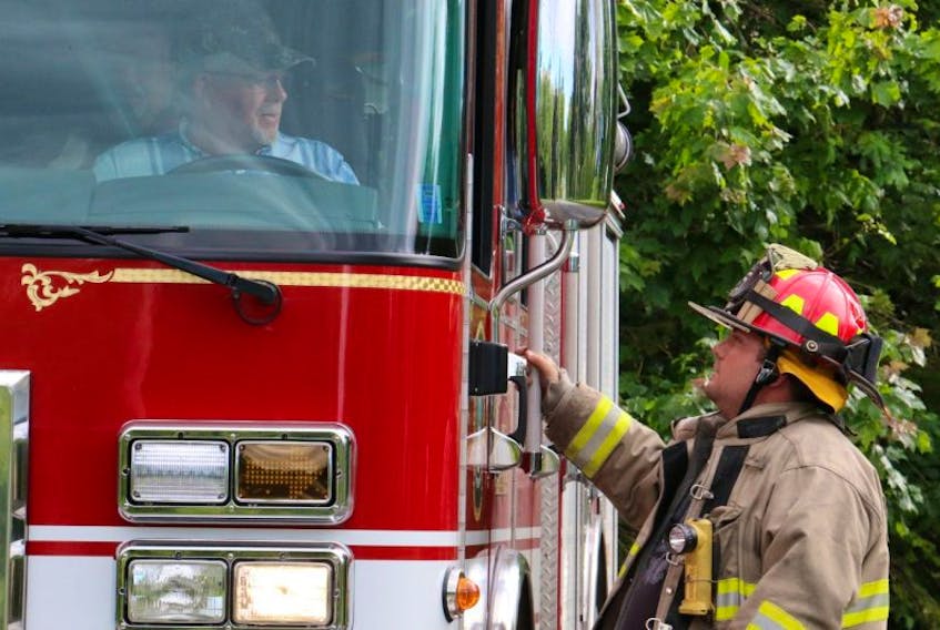 Capt. Bill Hazel, of the Hantsport Fire Department, speaks with driver Ronnie Starratt while preparing to head down to the scene.