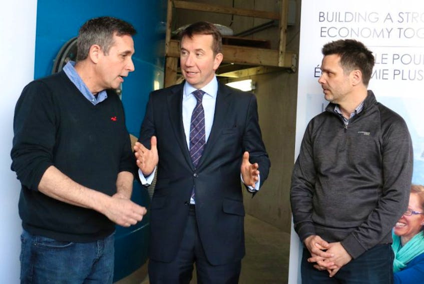 From left, David Roberts, the production director at Sustainable Fish Farming Ltd., Kings Hants MP Scott Brison, and Kirk Havercroft, the company's CEO, chat following a federal funding announcement April 21.