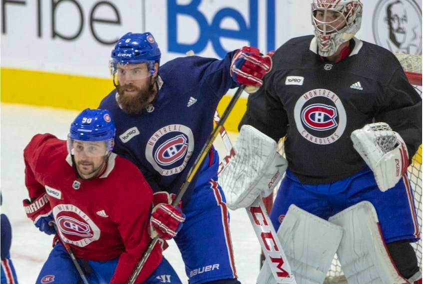 Canadiens defenceman Shea Weber defends against forward Tomas Tatar in front of goalie Carey Price Monday on first day of training camp at the Bell Sports Complex in Brossard as Phase 3 of the NHL’s Return to Play Plan began.