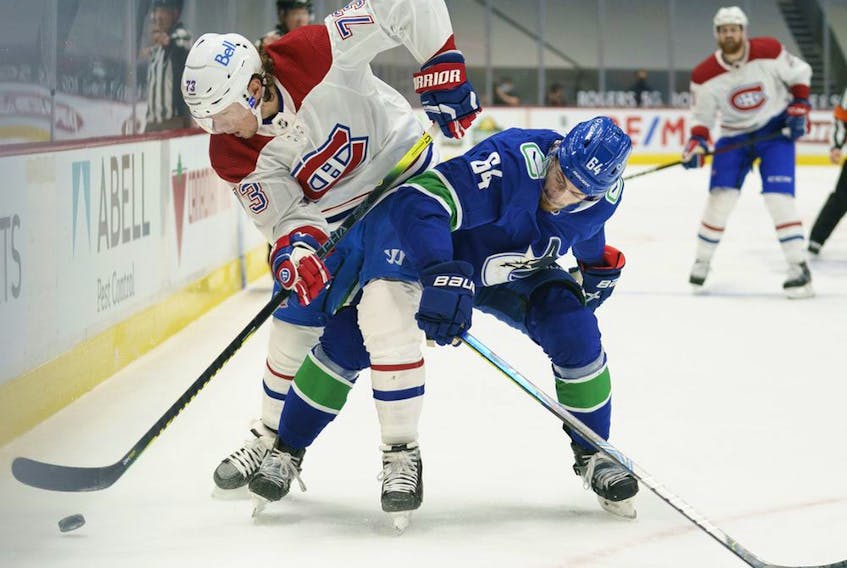 Canadiens' Tyler Toffoli battles Canucks' Tyler Motte for control of the puck during first period Thursday night in Vancouver.  