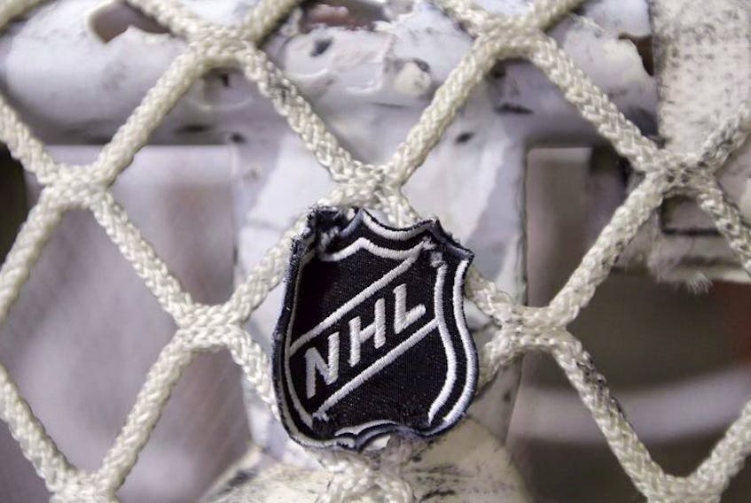 In this file photo taken Sept. 17, 2012, the NHL logo is seen on a goal at a Nashville Predators practice rink in Nashville, Tenn.