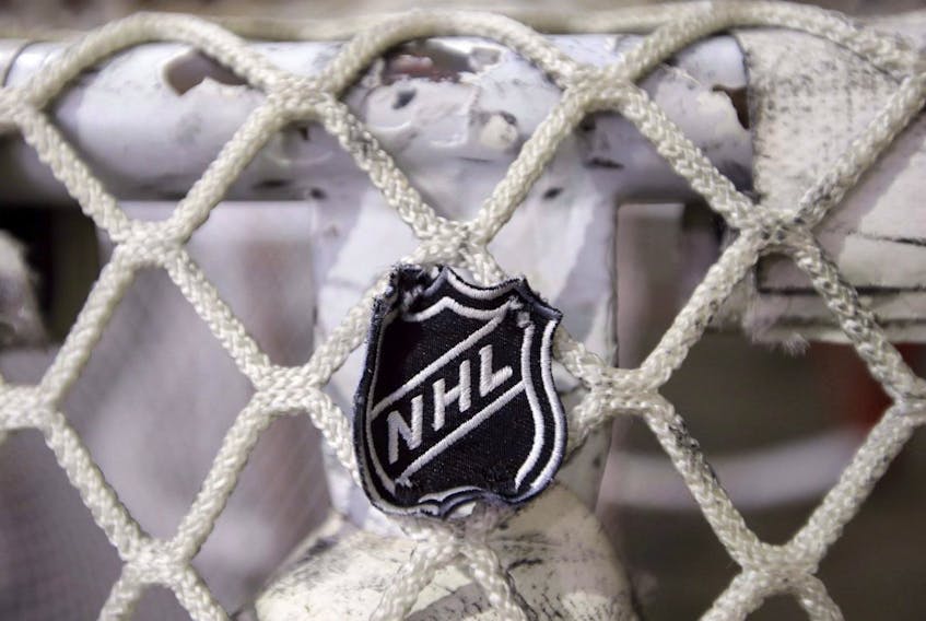 The NHL logo is seen on a goal at a Nashville Predators practice rink in Nashville, Tenn. 