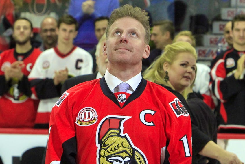 Former Ottawa Senators player Daniel Alfredsson watches as a banner with his retired jersey number 11, is raised to the rafters in Ottawa, Thursday December 29, 2016. 