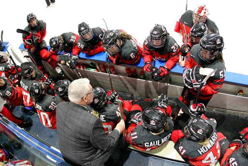 Team Canada players listen as coach Perry Pearn gives directions at the National Women's Team Rivalry Series in London, Ont., on Feb. 12, 2019.