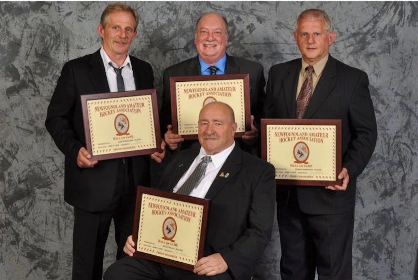 <p>Hockey Newfoundland and Labrador inducted four members into its Hall of Fame over the weekend in Gander. The new inductees are, from left, Juan Strickland (player), Brian Rogers (media category) and Charlie Babstock (player). Seated is builder Wally Dalley.</p>