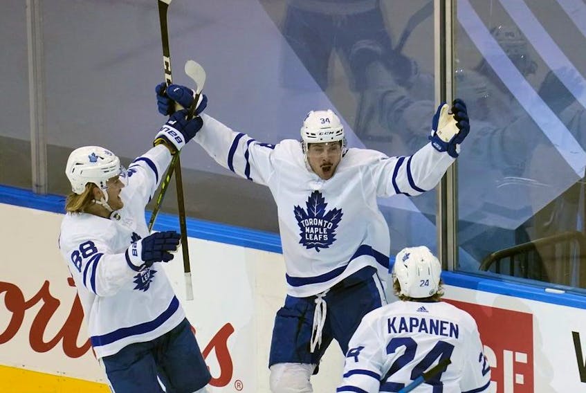 Toronto Maple Leafs forward Auston Matthews celebrates with forward William Nylander and forward Kasperi Kapanen after scoring the game winning goal against the Columbus Blue Jackets  during overtime of game four of the Eastern Conference qualifications at Scotiabank Arena. 