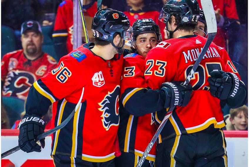 Mar 6, 2020; Calgary, Alberta, CAN; Calgary Flames left wing Johnny Gaudreau (13) celebrates with teammates after scoring a goal against the Arizona Coyotes during the first period at Scotiabank Saddledome. Mandatory Credit: Sergei Belski-USA TODAY Sports ORG XMIT: USATSI-406039