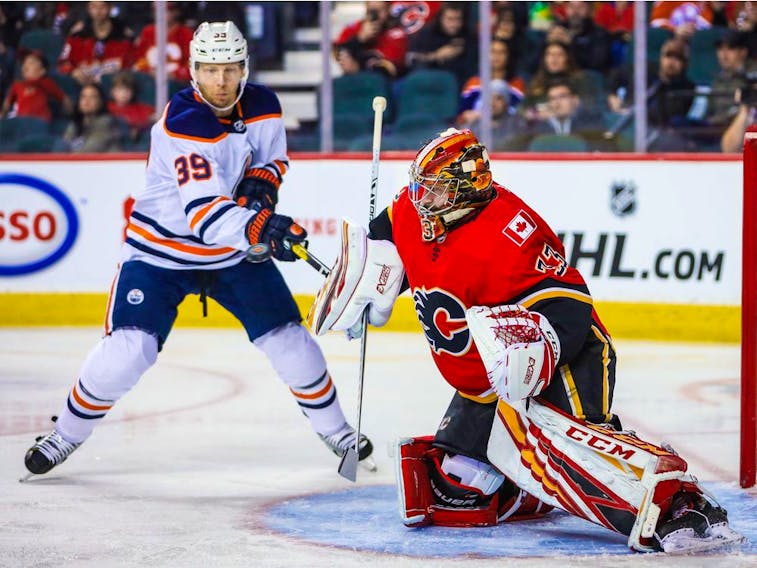 Calgary Flames goaltender Cam Talbot (39) makes a save as Edmonton Oilers center Leon Draisaitl (29) tries to score during the second period at Scotiabank Saddledome. 
