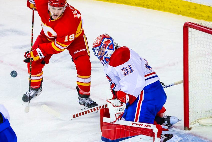 Canadiens goaltender Carey Price makes a save as Flames' Matthew Tkachuk tries to score during the second period at Scotiabank Saddledome in Calgary on Saturday, March 13, 2021.