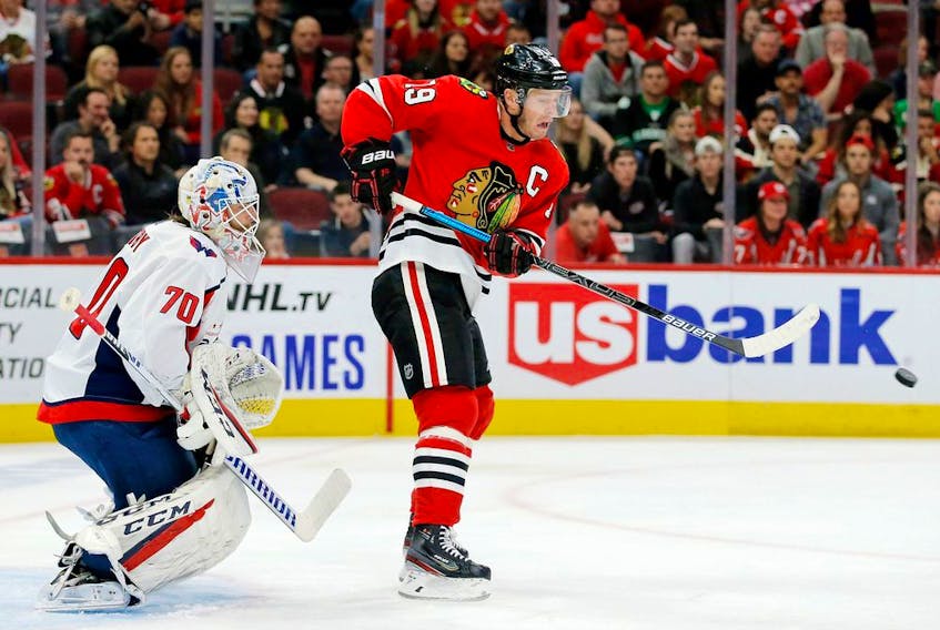 Chicago Blackhawks centre Jonathan Toews deflects the puck in front of Washington Capitals' goaltender Braden Holtby during NHL action earlier this season.
