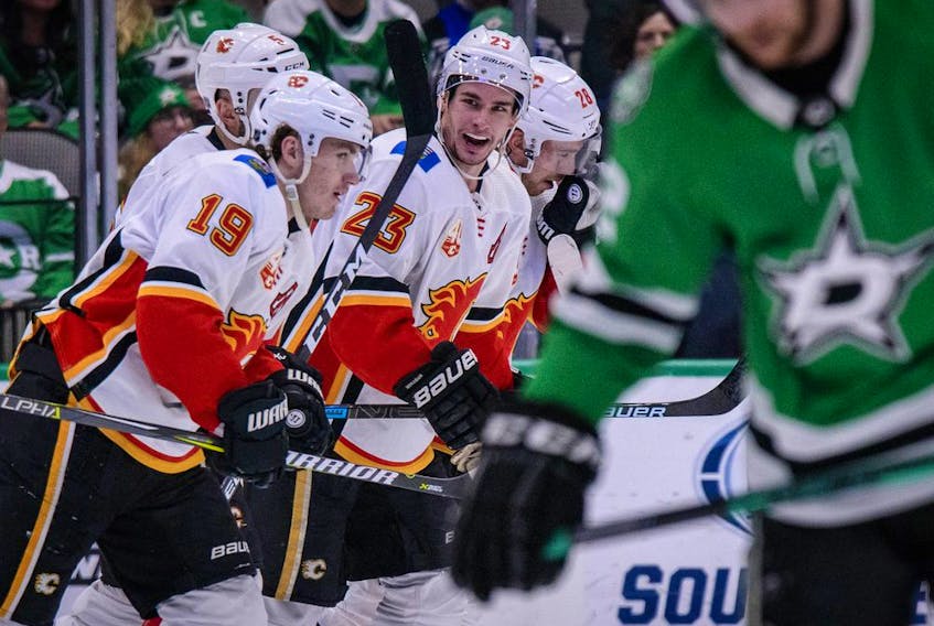 The Calgary Flames’ Matthew Tkachuk (19) and Sean Monahan (23) celebrate a goal scored by Tkachuk against the Dallas Stars at the American Airlines Center in Dallas on Dec. 22, 2019. Jerome Miron/USA TODAY Sports