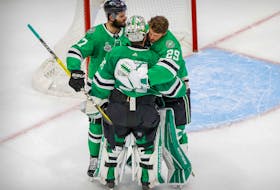 Dallas Stars right wing Alexander Radulov (47) and goaltender Jake Oettinger (29) hug goaltender Anton Khudobin (35) as the Tampa Bay Lightning celebrate winning the Stanley Cup in game six of the 2020 Stanley Cup Final at Rogers Place. 