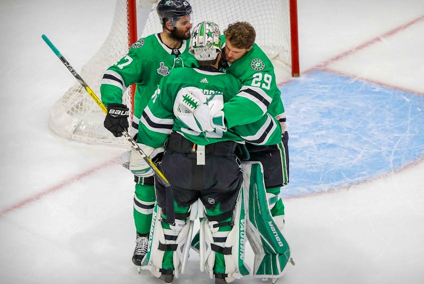 Dallas Stars right wing Alexander Radulov (47) and goaltender Jake Oettinger (29) hug goaltender Anton Khudobin (35) as the Tampa Bay Lightning celebrate winning the Stanley Cup in game six of the 2020 Stanley Cup Final at Rogers Place. 