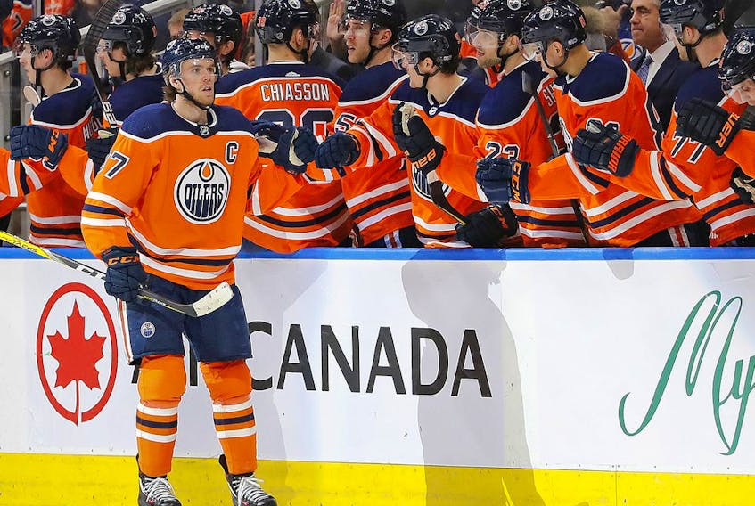 Edmonton Oilers forward Connor McDavid (97) celebrates with teammates on the bench after scoring a goal against the Arizona Coyotes at Rogers Place on Jan. 18, 2020.