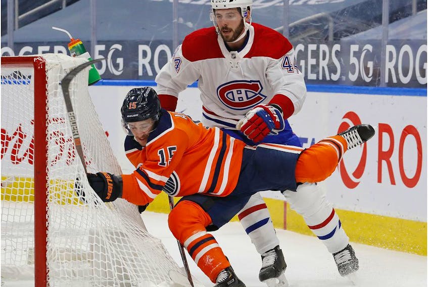 Canadiens defenecman Joel Edmundson (44) trips up Edmonton Oilers forward Josh Archibald (15) during the first period at Rogers Place on Saturday, Jan. 16, 2021.