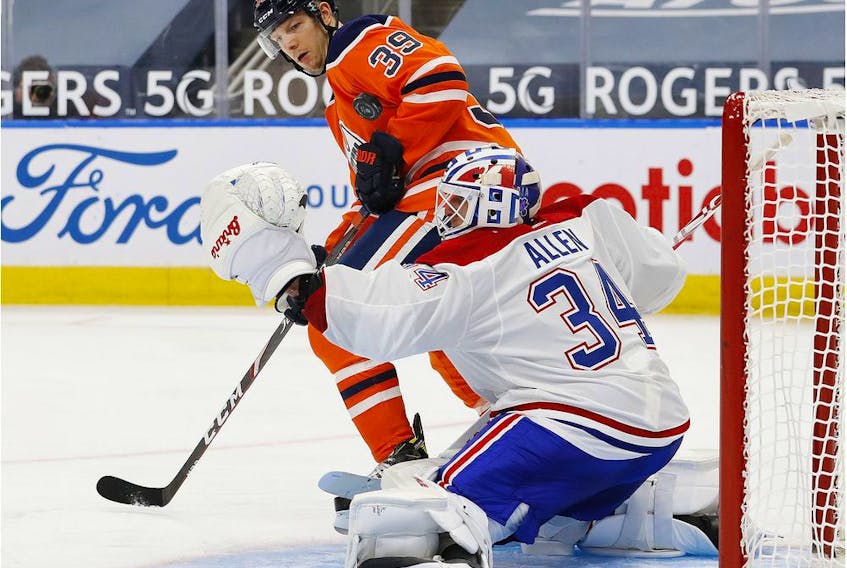 A shot deflects off Oilers forward Alex Chiasson in front of Canadiens goaltender Jake Allen during the third period at Rogers Place in Edmonton Monday night.
