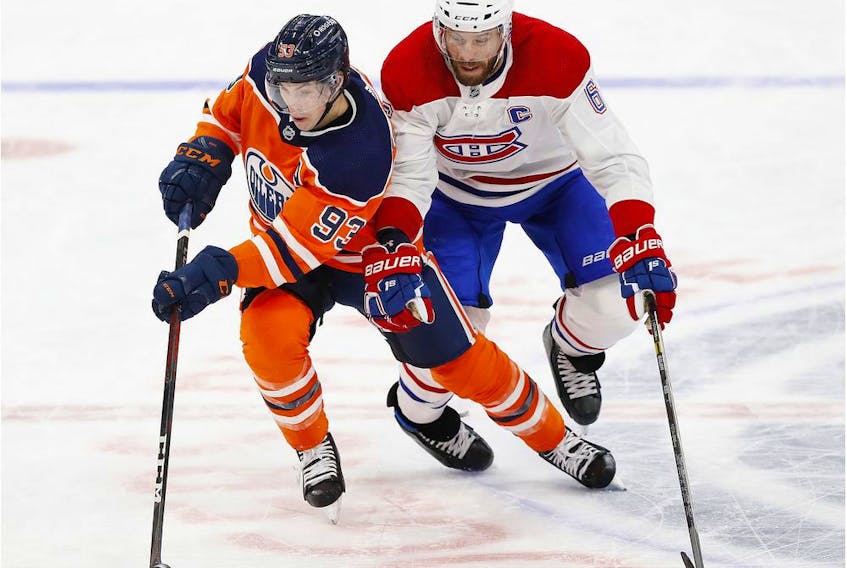 Montreal Canadiens defenceman Shea Weber and Edmonton Oilers forward Ryan Nugent-Hopkins chase a loose puck during the third period at Rogers Place in Edmonton on Jan. 18, 2021. 