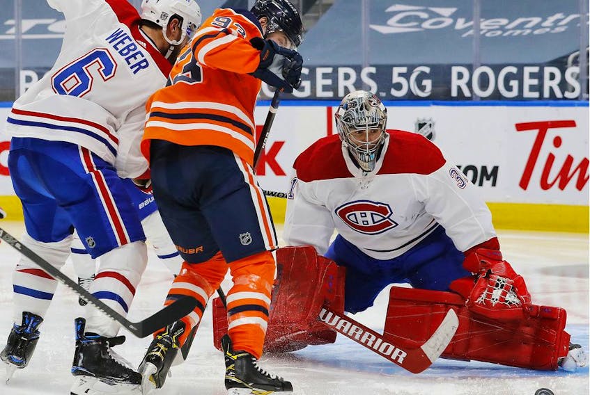 Canadiens goaltender Carey Price makes a save on Oilers forward Ryan Nugent-Hopkins (93) at Rogers Place in Edmonton on Saturday, Jan. 16, 2021.