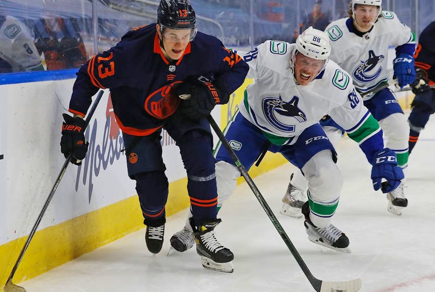 New Vancouver Canucks' defenceman Nate Schmidt battles with Jesse Puljujarvi of the Edmonton Oilers during Thursday's NHL game in the Alberta capital.
