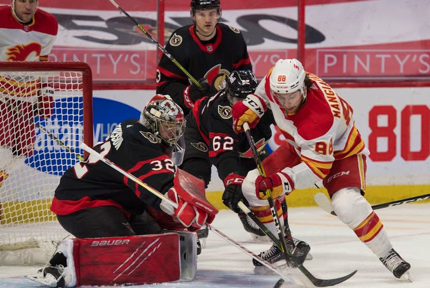 Calgary Flames left wing Andrew Mangiapane (88) moves in for a shot against Ottawa Senators goalie Filip Gustavsson (32) in the first period at the Canadian Tire Centre in Ottawa on Monday, March 22, 2021. 