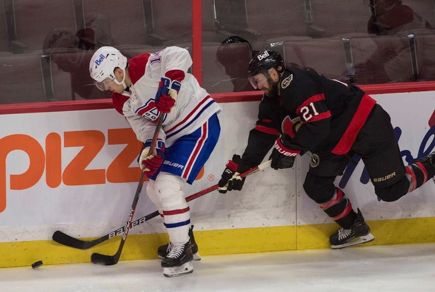 Canadiens centre Nick Suzuki (14) and Ottawa Senators centre Derek Stepan (21) battle for the puck in the third period at the Canadian Tire Centre in Ottawa on Sunday.