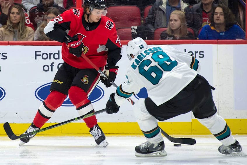  Senators defenceman Thomas Chabot shoots the puck past Sharks centre Melker Karlsson (68) in the second period of Sunday’s game in Ottawa.