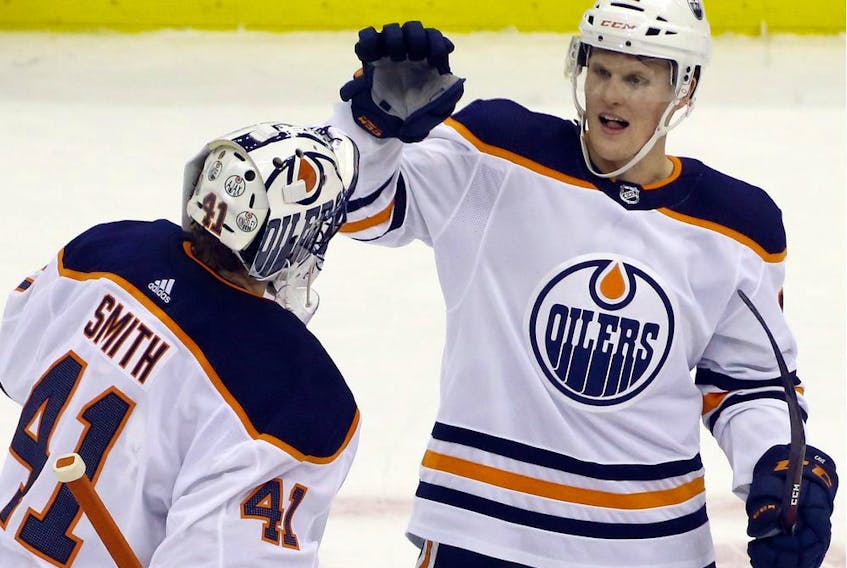  Edmonton Oilers goaltender Mike Smith (41) and centre Colby Cave (12) celebrate after defeating the Pittsburgh Penguins at PPG PAINTS Arena. The Oilers won 2-1 in overtime.