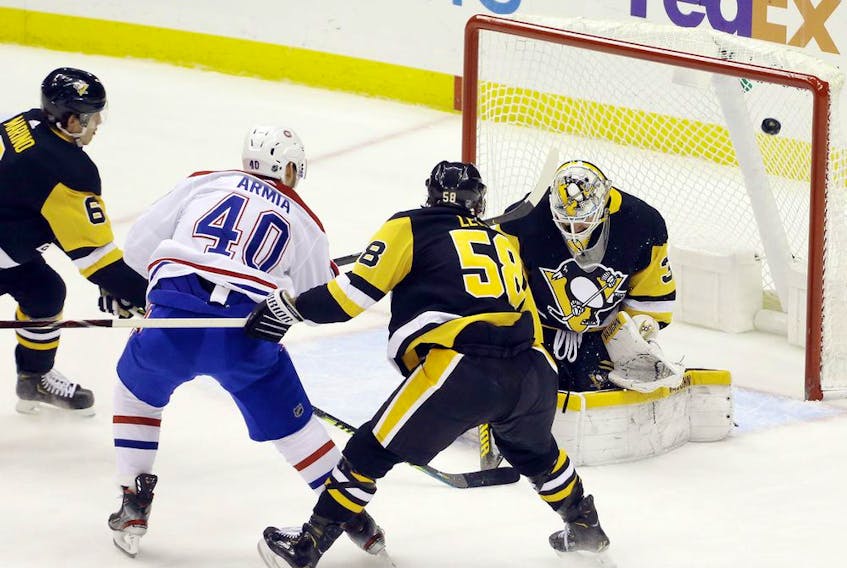Canadiens winger Joel Armia scores his 11th goal of the season against Penguins goaltender Tristan Jarry as Pens defencemen John Marino, left, and Kris Letang defend Tuesday night at PPG Paints Arena in Pittsburgh. 