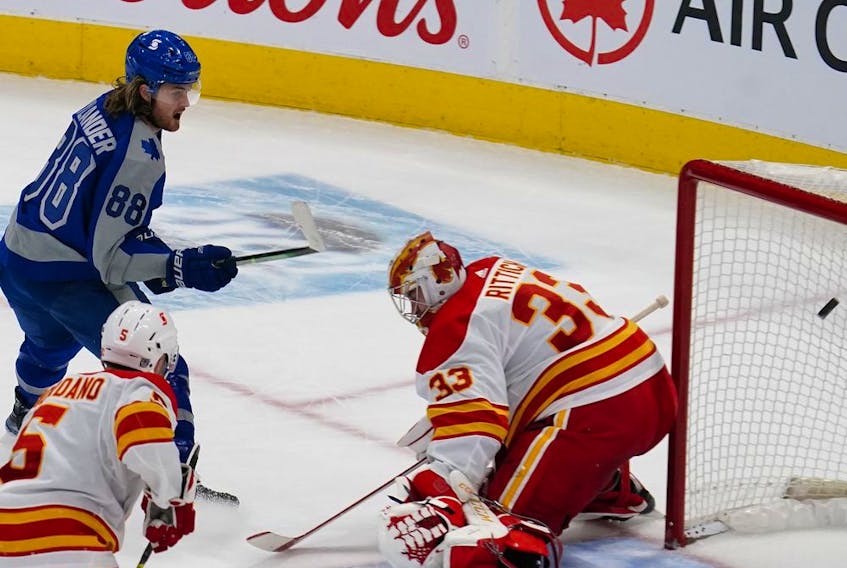 Maple Leafs forward William Nylander deposits the game-winning goal past Calgary Flames goaltender David Rittich during overtime at Scotiabank Arena in Toronto on Wednesday night.