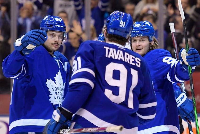 Toronto Maple Leafs forward William Nylander celebrates scoring against Calgary Flames with forwards John Tavares  and Auston Matthews in the third period at Scotiabank Arena. 