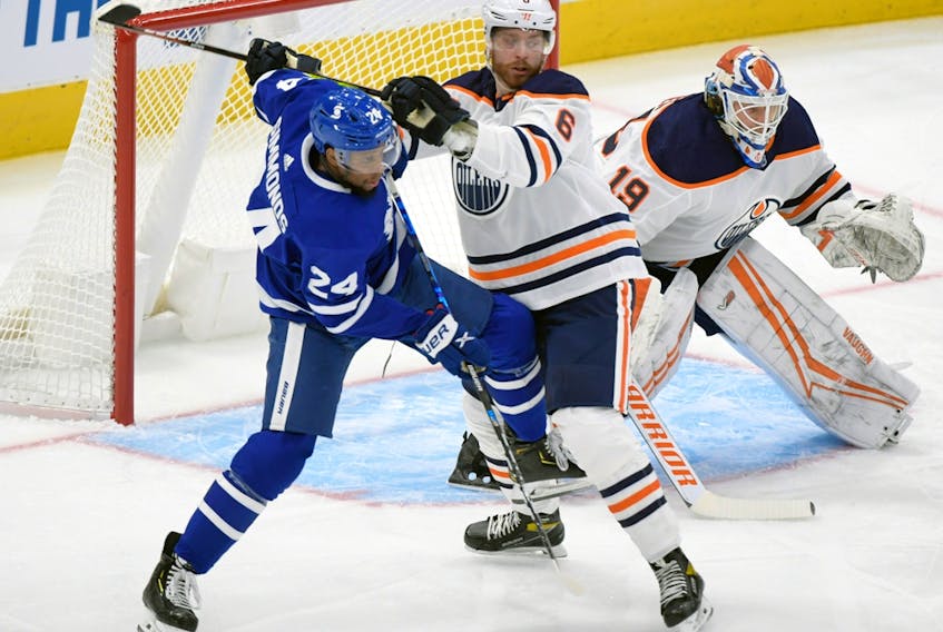 Jan 20, 2021; Toronto, Ontario, CAN; Edmonton Oilers defenseman Adam Larsson (6) battles for position with Toronto Maple Leafs forward Wayne Simmonds (24) in front of goalie Mikko Koskinen (19) in the first period at Scotiabank Arena. 